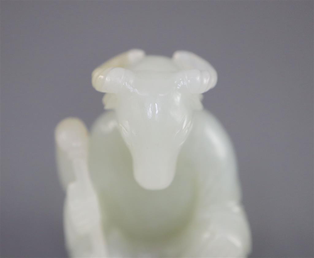 A Chinese pale celadon jade seated figure of a ram-headed immortal, 4.9cm high